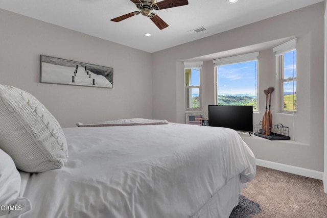 carpeted bedroom featuring visible vents, recessed lighting, and multiple windows