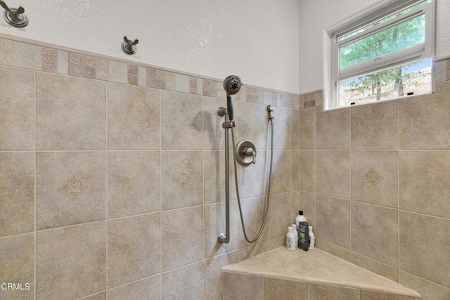 interior details with a tile shower