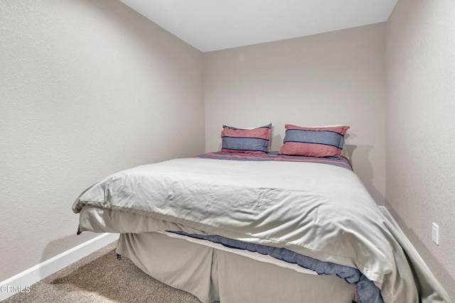 carpeted bedroom with baseboards