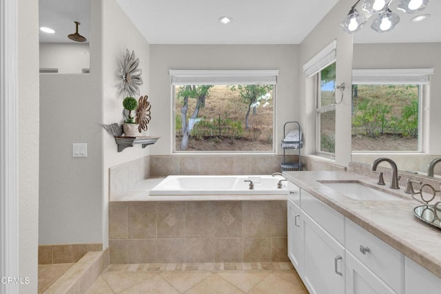 bathroom with recessed lighting, tile patterned flooring, a bath, and vanity