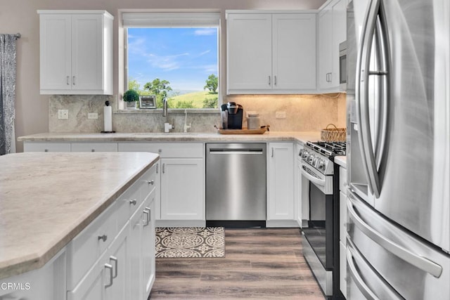 kitchen featuring white cabinetry, appliances with stainless steel finishes, and a sink