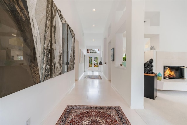hall featuring light tile patterned floors and recessed lighting