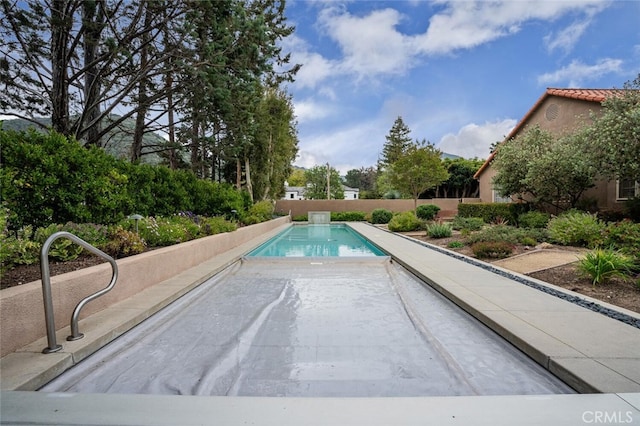 view of swimming pool with a fenced in pool and fence