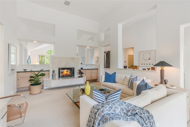 carpeted living room featuring a fireplace