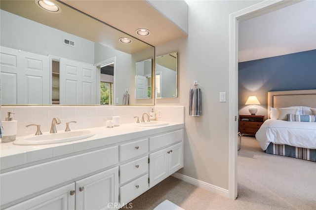 bathroom featuring recessed lighting, baseboards, visible vents, and a sink