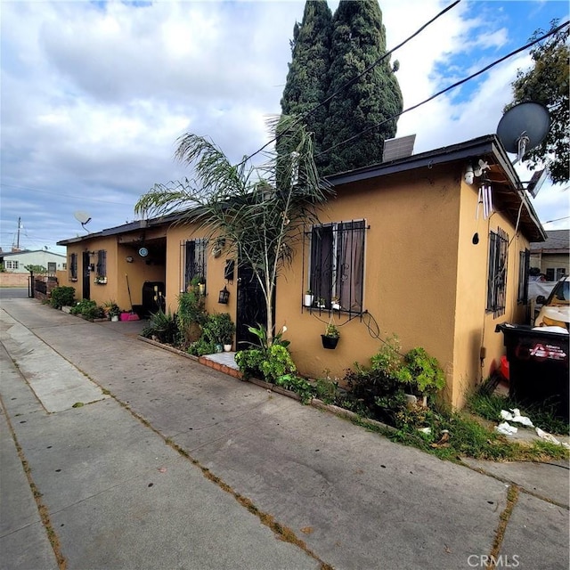view of front of home with concrete driveway and stucco siding
