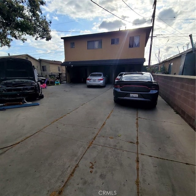 exterior space with stucco siding, driveway, and a garage