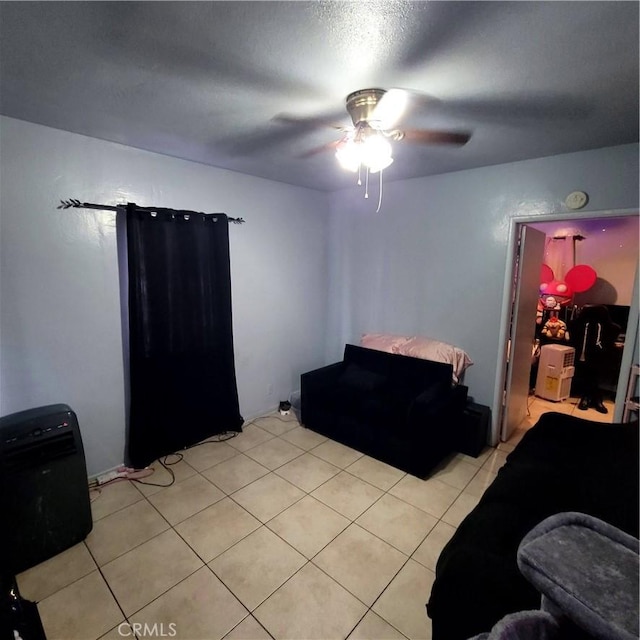bedroom with a ceiling fan and light tile patterned floors