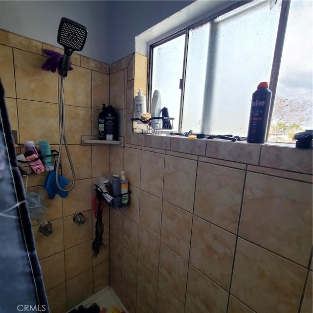 bathroom with a tile shower