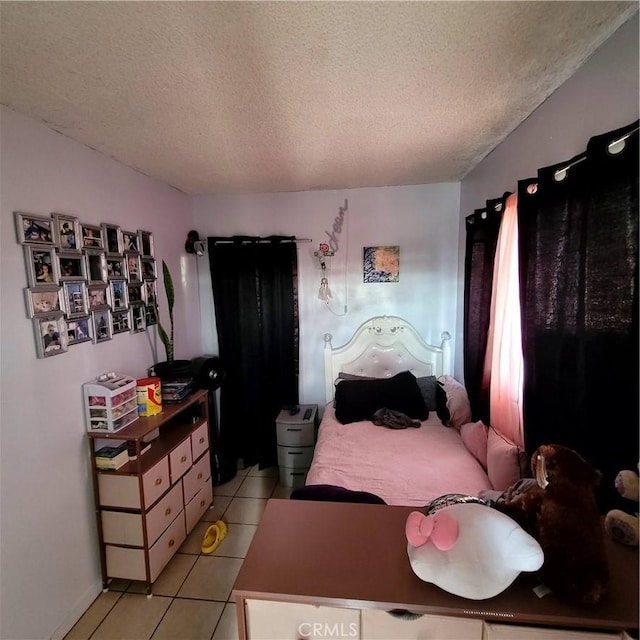 bedroom featuring a textured ceiling and light tile patterned floors
