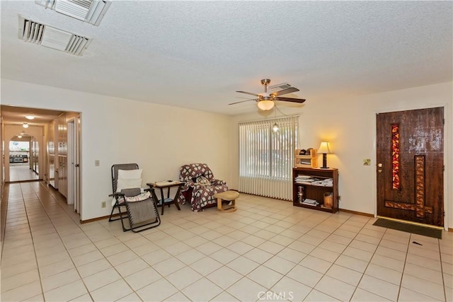 7486 Earhart Ave, Hesperia, CA 92345 - sitting room featuring ceiling fan, light tile patterned floors, a textured ceiling, and baseboards
