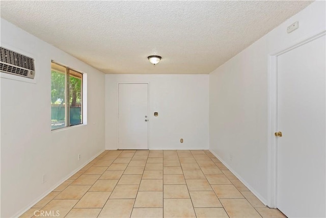 7486 Earhart Ave, Hesperia, CA 92345 - unfurnished room featuring a wall unit AC and a textured ceiling