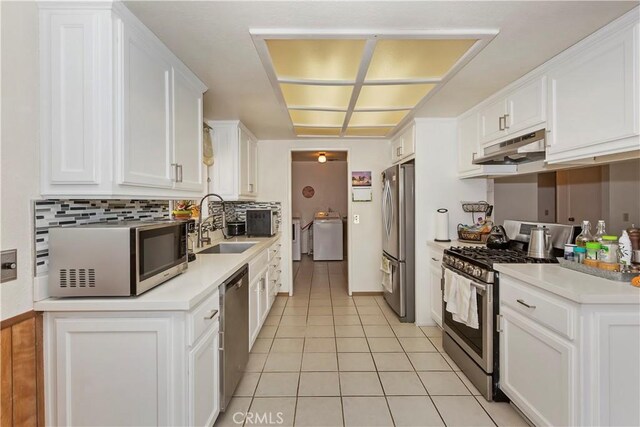 7486 Earhart Ave, Hesperia, CA 92345 - kitchen featuring stainless steel appliances, a sink, under cabinet range hood, white cabinetry, and light tile patterned flooring