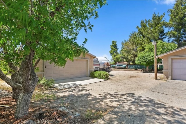 7486 Earhart Ave, Hesperia, CA 92345 - view of yard featuring an outbuilding and a garage