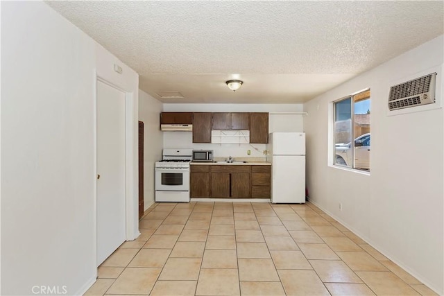 7486 Earhart Ave, Hesperia, CA 92345 - kitchen with white appliances, a sink, under cabinet range hood, a textured ceiling, and light countertops