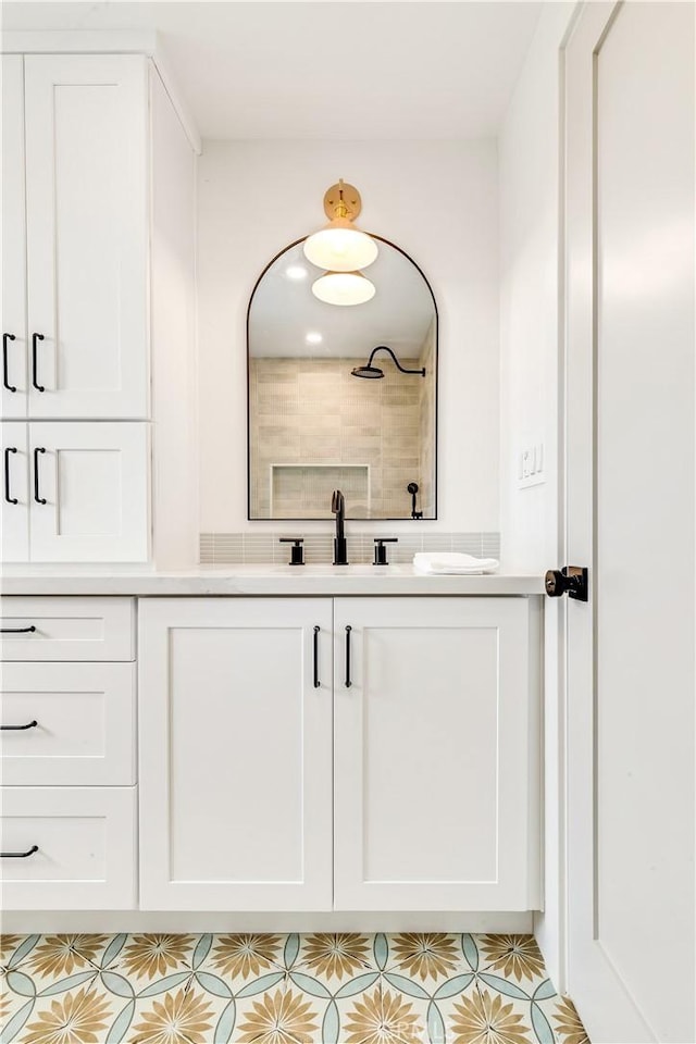 bathroom with vanity, tile patterned flooring, and tiled shower