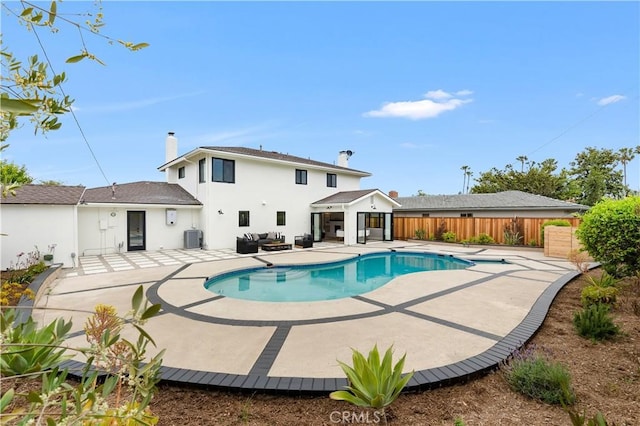 view of swimming pool featuring a fenced in pool, fence, cooling unit, and a patio area