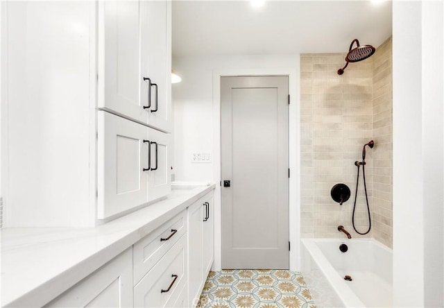 full bathroom with tile patterned floors, vanity, and  shower combination