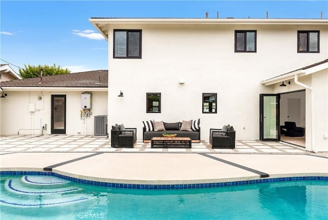 back of house featuring stucco siding, central air condition unit, and a patio