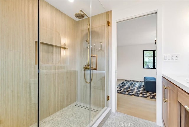 full bathroom with an enclosed shower and vanity
