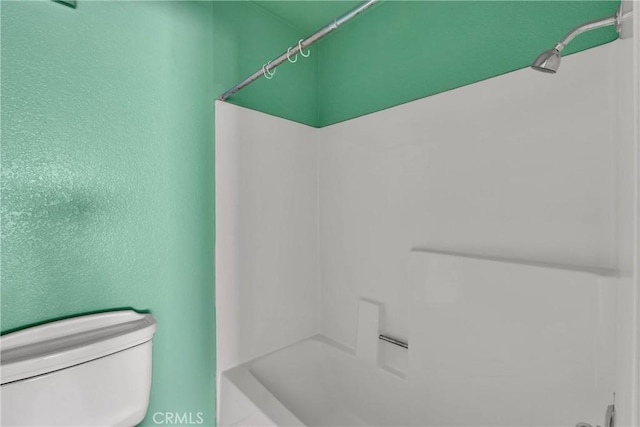 bathroom with toilet and walk in shower