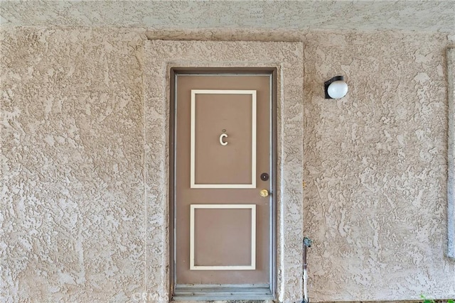 property entrance featuring stucco siding