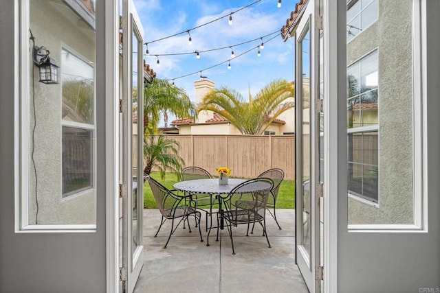 balcony with outdoor dining area and a patio area