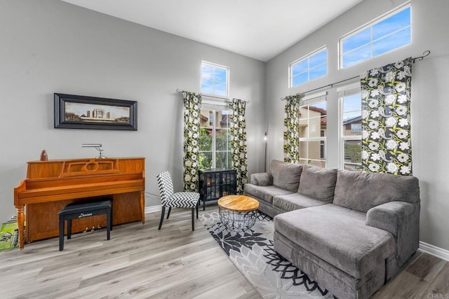 living area with baseboards and light wood-style flooring