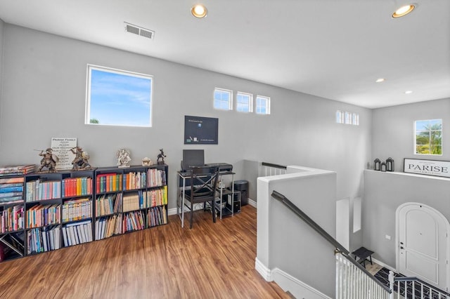 interior space featuring recessed lighting, baseboards, visible vents, and wood finished floors