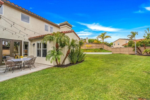 view of yard featuring fence and a patio area
