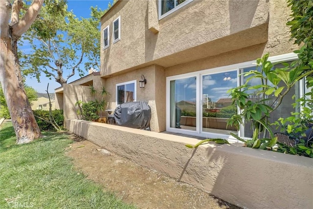 rear view of house with stucco siding