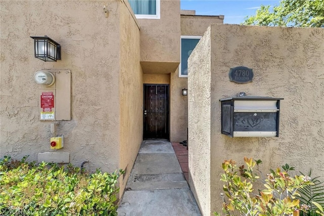entrance to property with stucco siding