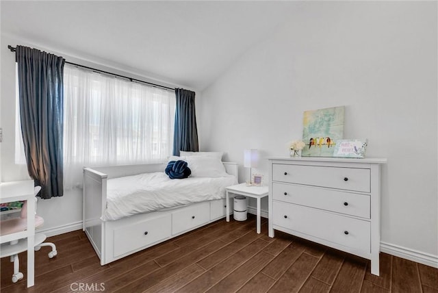 bedroom featuring dark wood-type flooring, baseboards, and vaulted ceiling