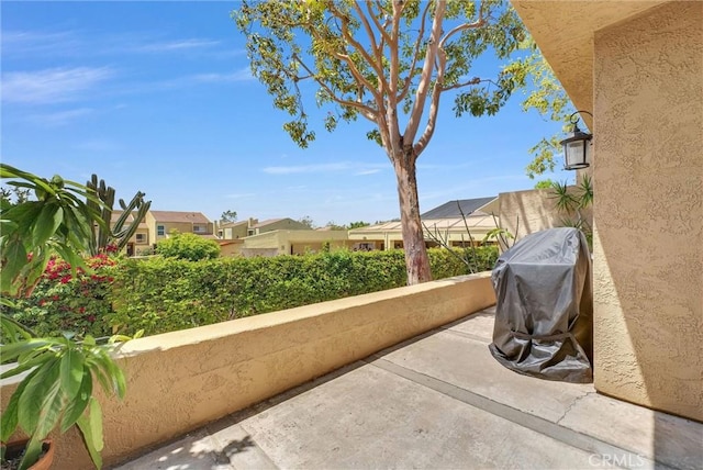 view of patio featuring a balcony and a residential view