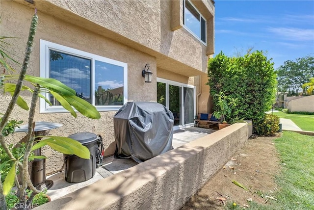 exterior space with a patio and stucco siding
