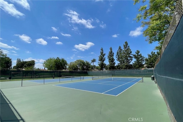 view of tennis court with fence