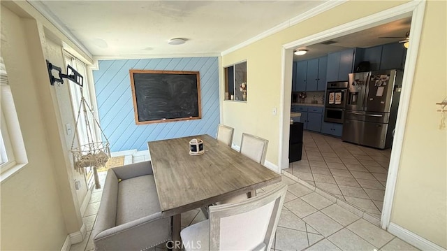 dining space with baseboards, ornamental molding, a ceiling fan, and light tile patterned floors