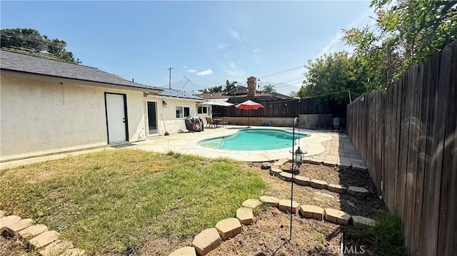 view of swimming pool with a yard, a fenced in pool, a fenced backyard, and a patio area