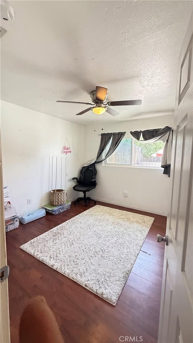 interior space featuring ceiling fan and wood finished floors