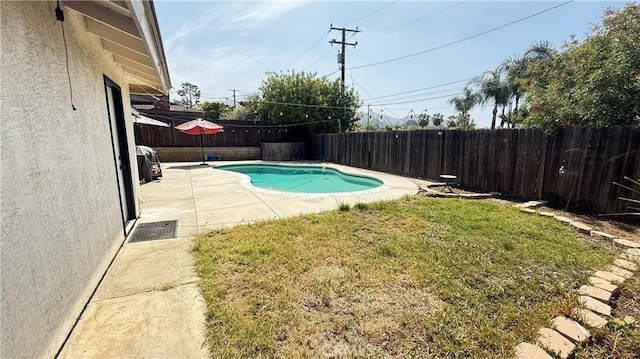 view of pool featuring a fenced backyard, a fenced in pool, a lawn, and a patio area