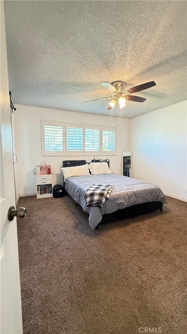 bedroom featuring carpet floors, a textured ceiling, ceiling fan, and baseboards