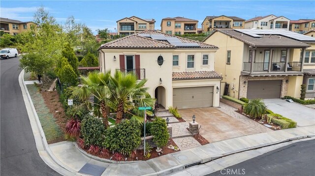 11 Cielo Arroyo, Mission Viejo, CA 92692 - view of front facade with a balcony, a garage, stucco siding, and a residential view