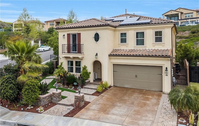 11 Cielo Arroyo, Mission Viejo, CA 92692 - mediterranean / spanish home with a balcony, roof mounted solar panels, a tile roof, stucco siding, and a garage