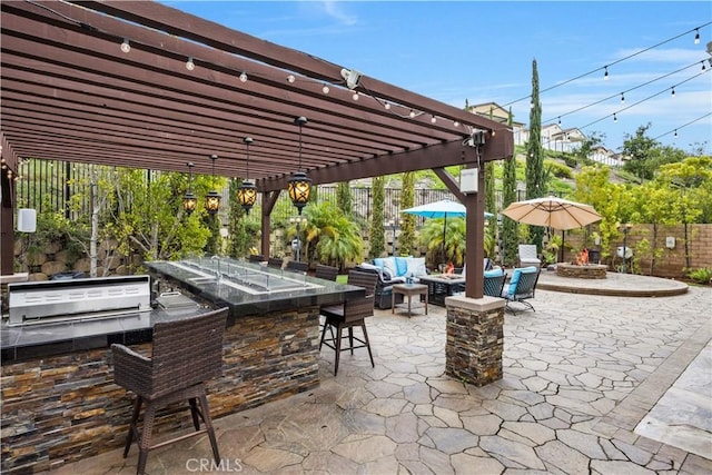 11 Cielo Arroyo, Mission Viejo, CA 92692 - view of patio featuring a pergola, exterior kitchen, an outdoor bar, and an outdoor living space with a fire pit