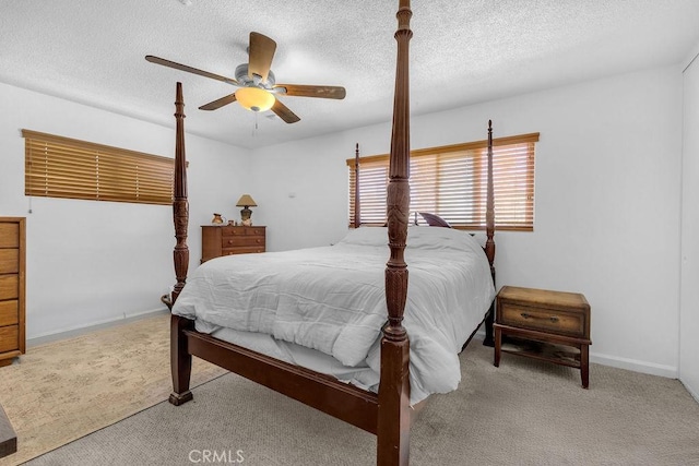 bedroom featuring carpet floors, a textured ceiling, and ceiling fan
