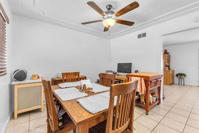 dining area featuring baseboards, ceiling fan, visible vents, and light tile patterned floors