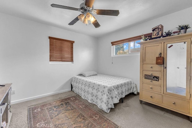 bedroom with carpet floors, baseboards, and a ceiling fan