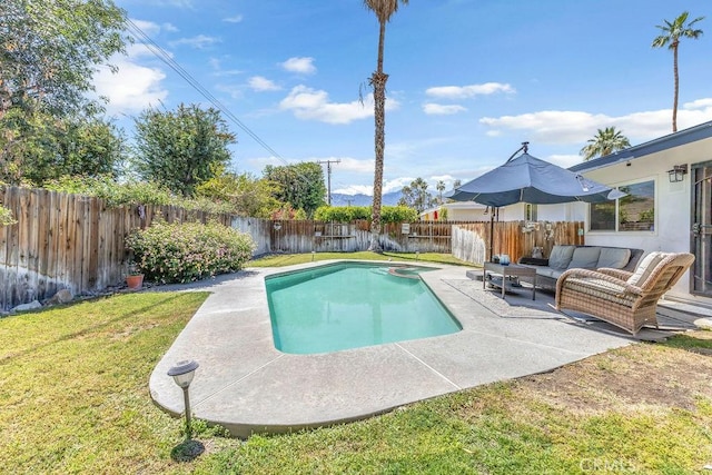 view of pool with a pool with connected hot tub, outdoor lounge area, a fenced backyard, a lawn, and a patio