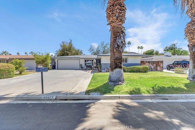 single story home with stucco siding, a garage, driveway, and a front lawn