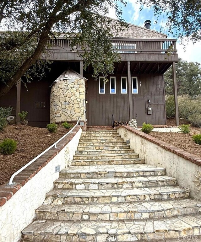 1909 Pioneer Way, Pine Mountain Club, CA 93222 - view of front of home with stairway and a deck